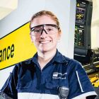 A smiling woman in a paramedic science uniform.