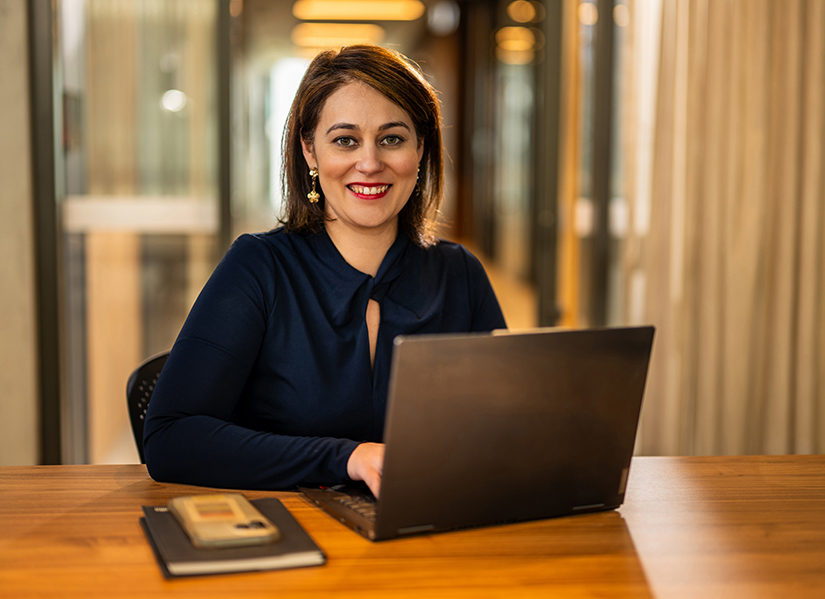 Image of Camilla Marshall sitting at laptop