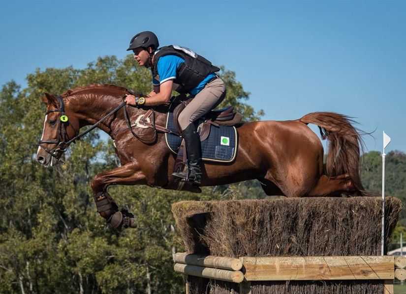 Brett Cantle jumping a chestnut horse