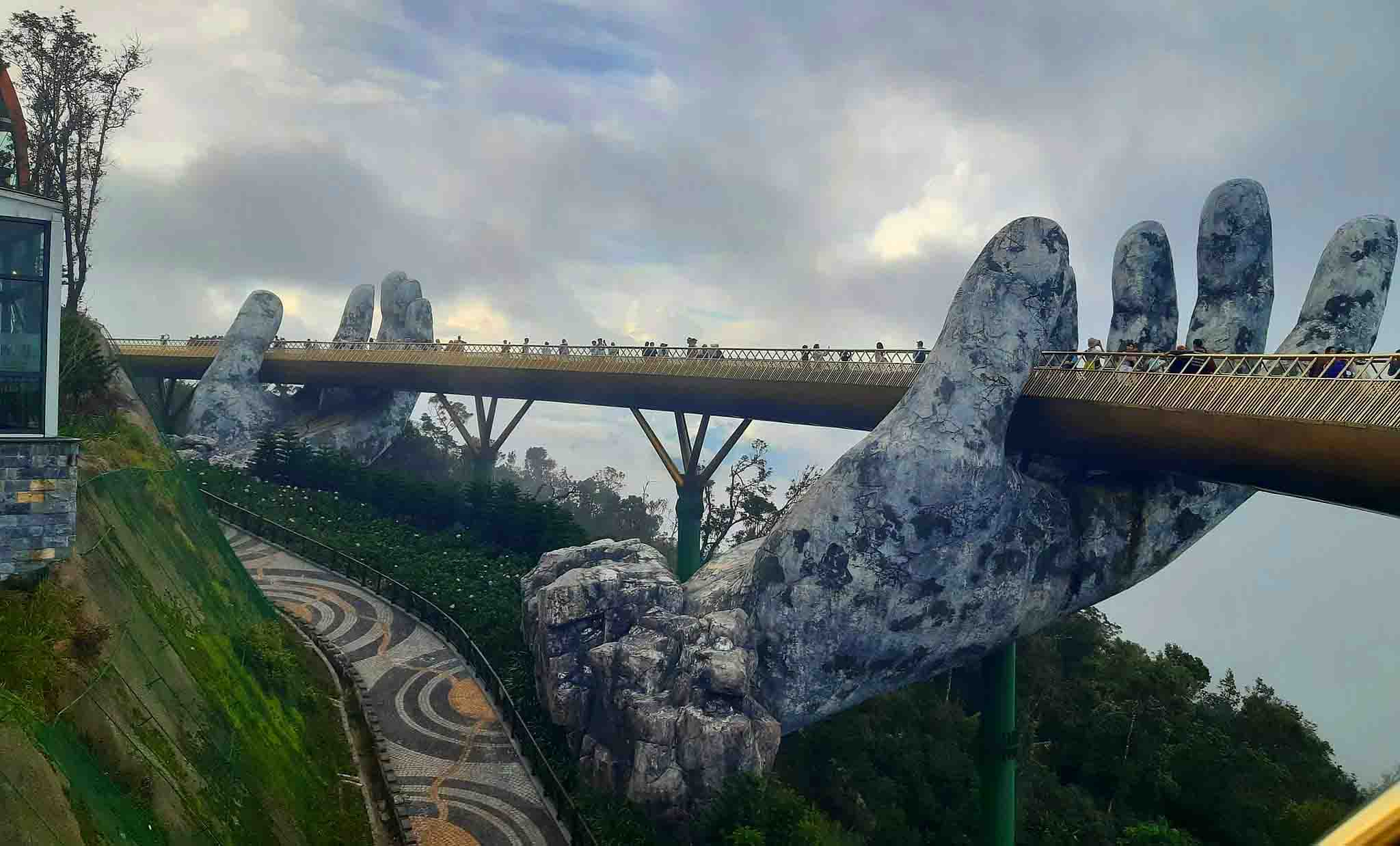 The Golden Bridge in Vietnam is a beam bridge with the walkway held between two giant stone hands.