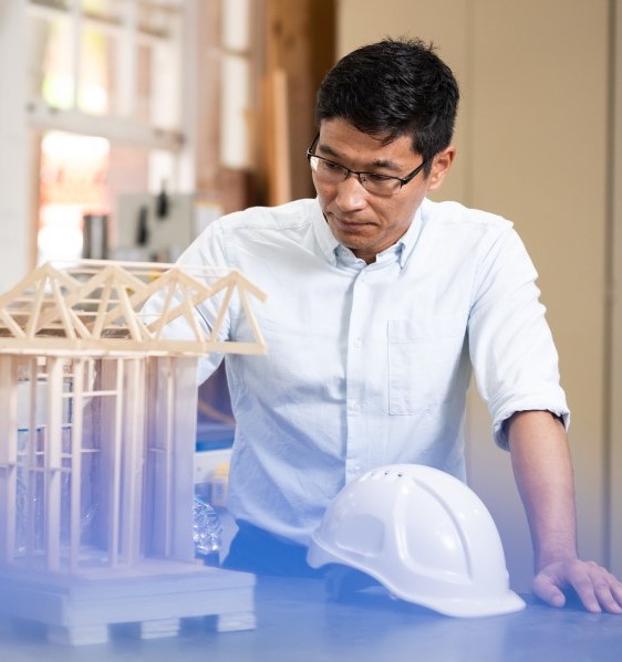 Purevdorj inspecting a building model