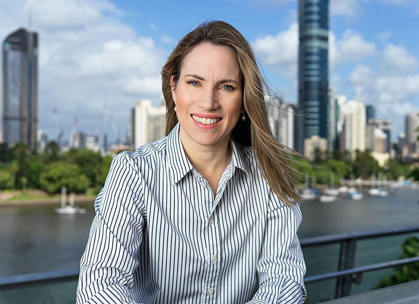 headshot of Deborah Henderson against the background of city skyscrapers