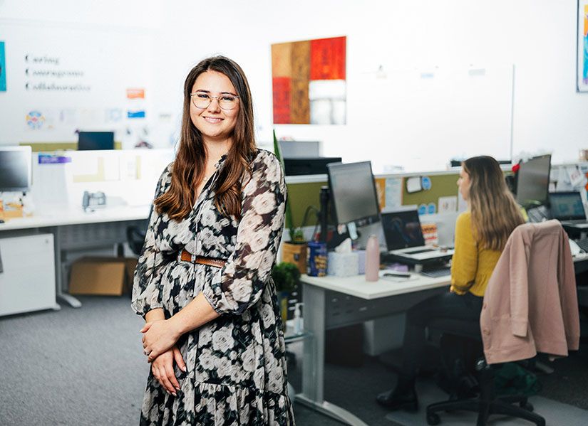 Smiling professional woman standing in an office