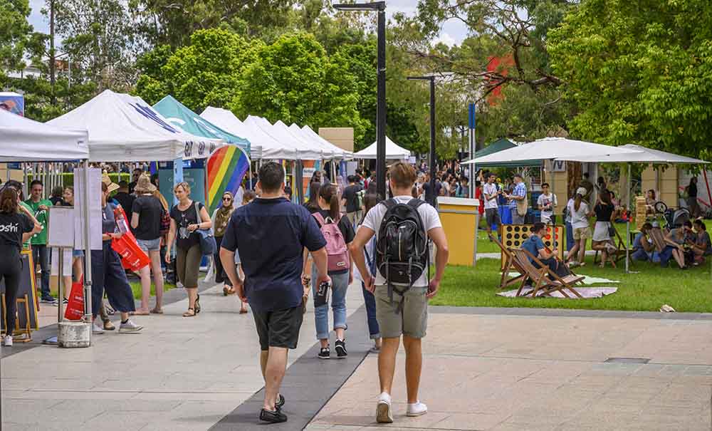 Tents, flags, games, and crowds welcome new students to QUT at Orientation week.