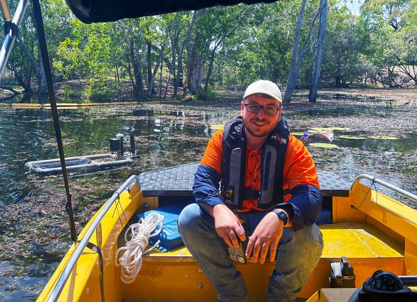 Biological Sciences graduate Daniel Lewis-Kuhl on a boat in the field.