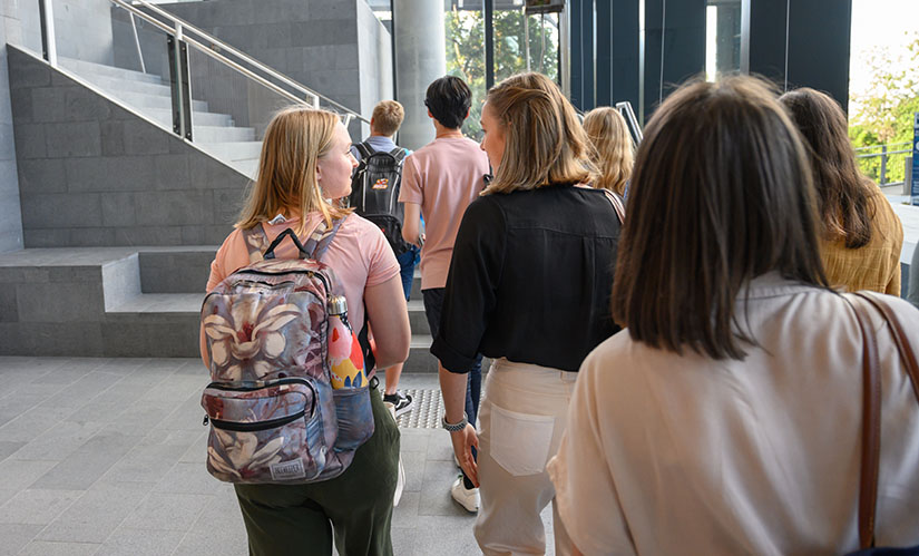 A group of students walk towards class.