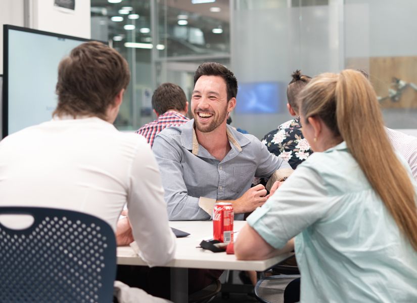 Student laughing in a team work environment