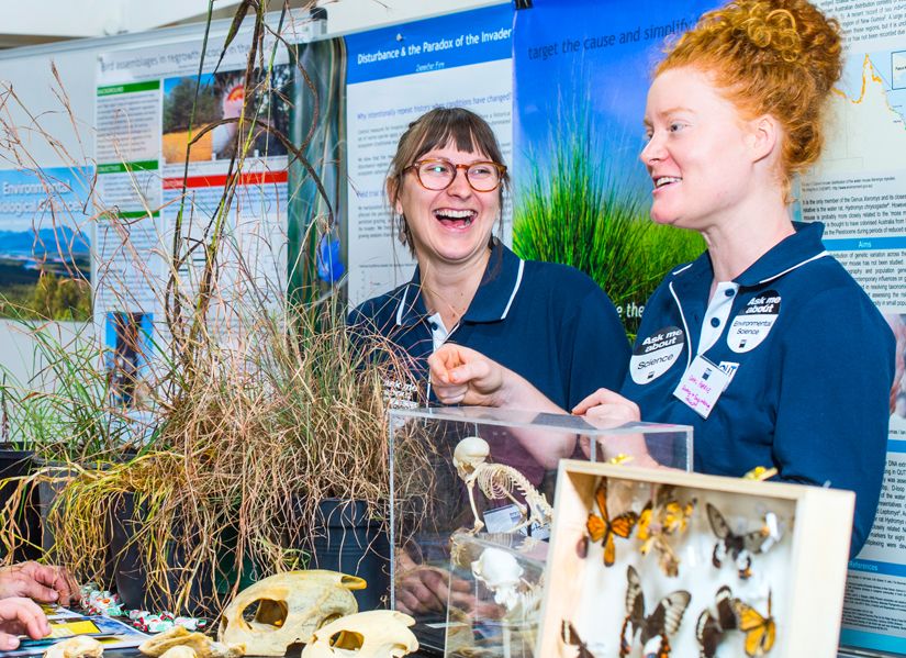 Two QUT scientists talking to Open Day attendees about their biology research