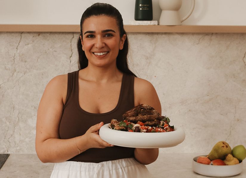 Jacqui Tombas looks at the camera holding a generous platter
