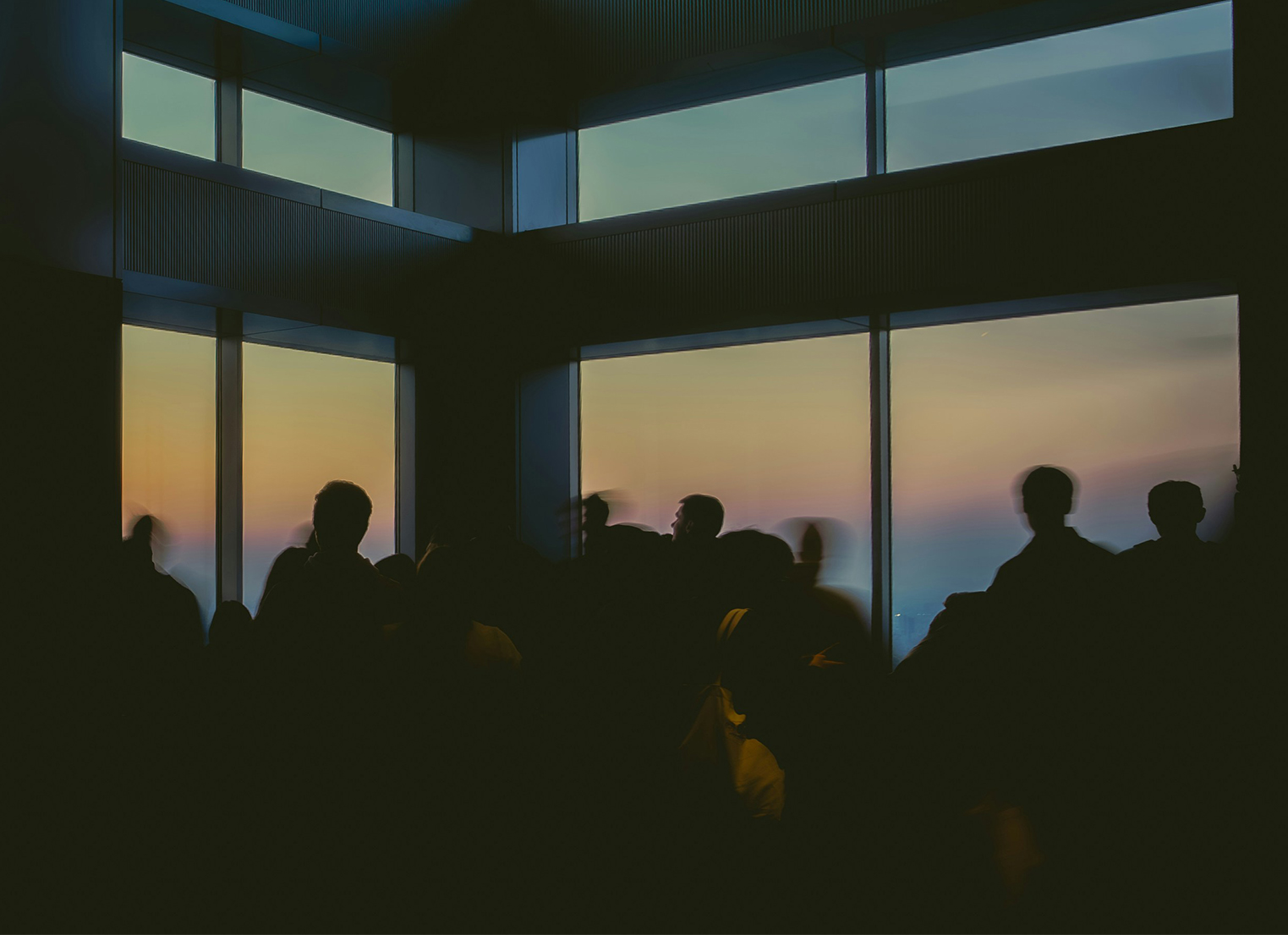People silhouetted against a window