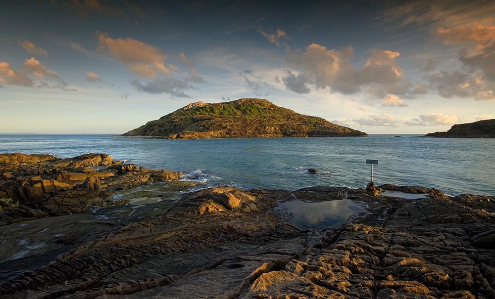 A sunset view of the ocean and islands.