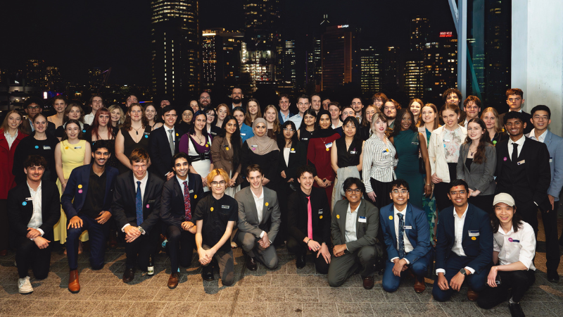 students and alumni stand together to celebrate the 2026 dean scholars networking event.