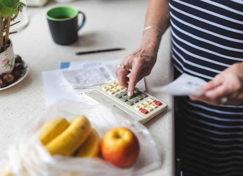 Photo of food and someone holding a calculator.