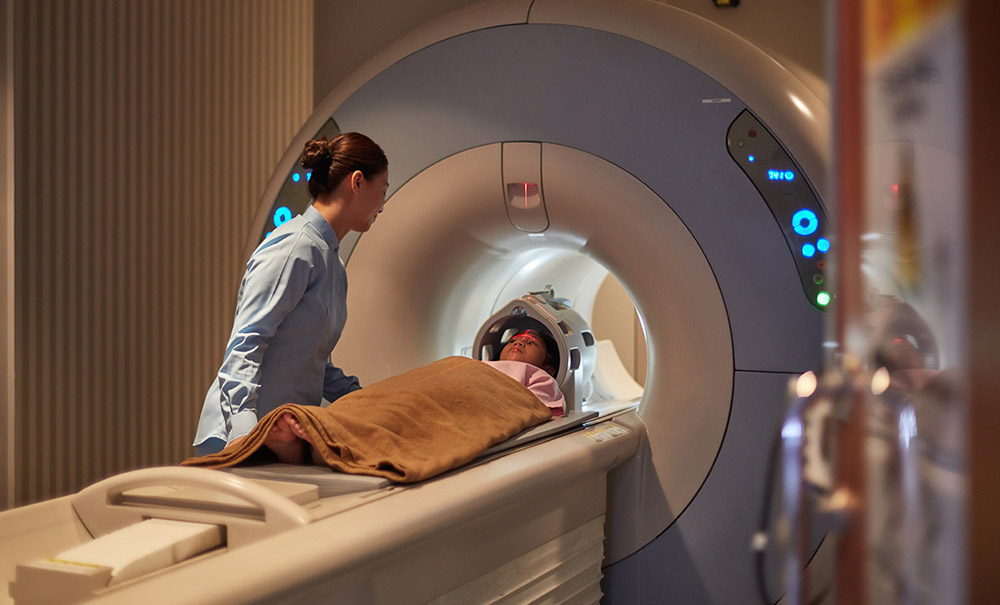 A technician reassures a child as they prepare to undergo an MRI scan.
