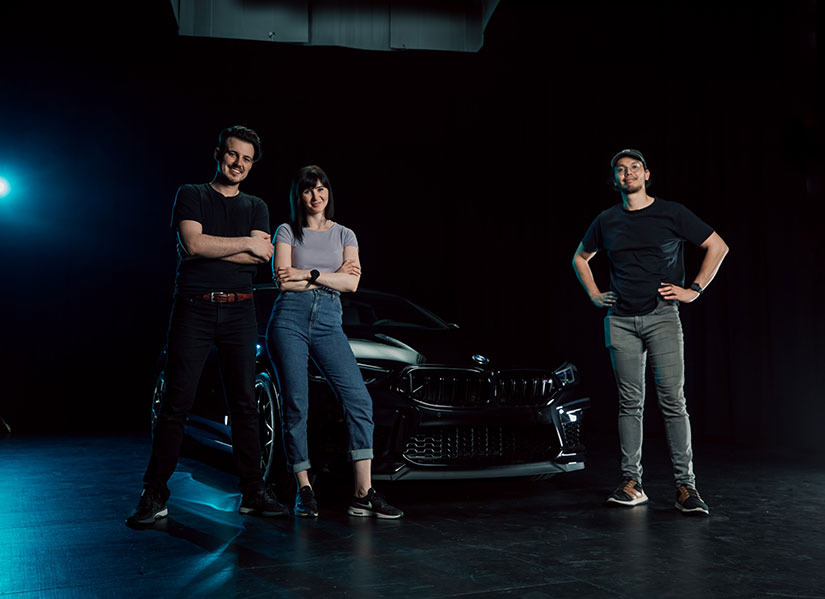 A group of people standing on a black stage