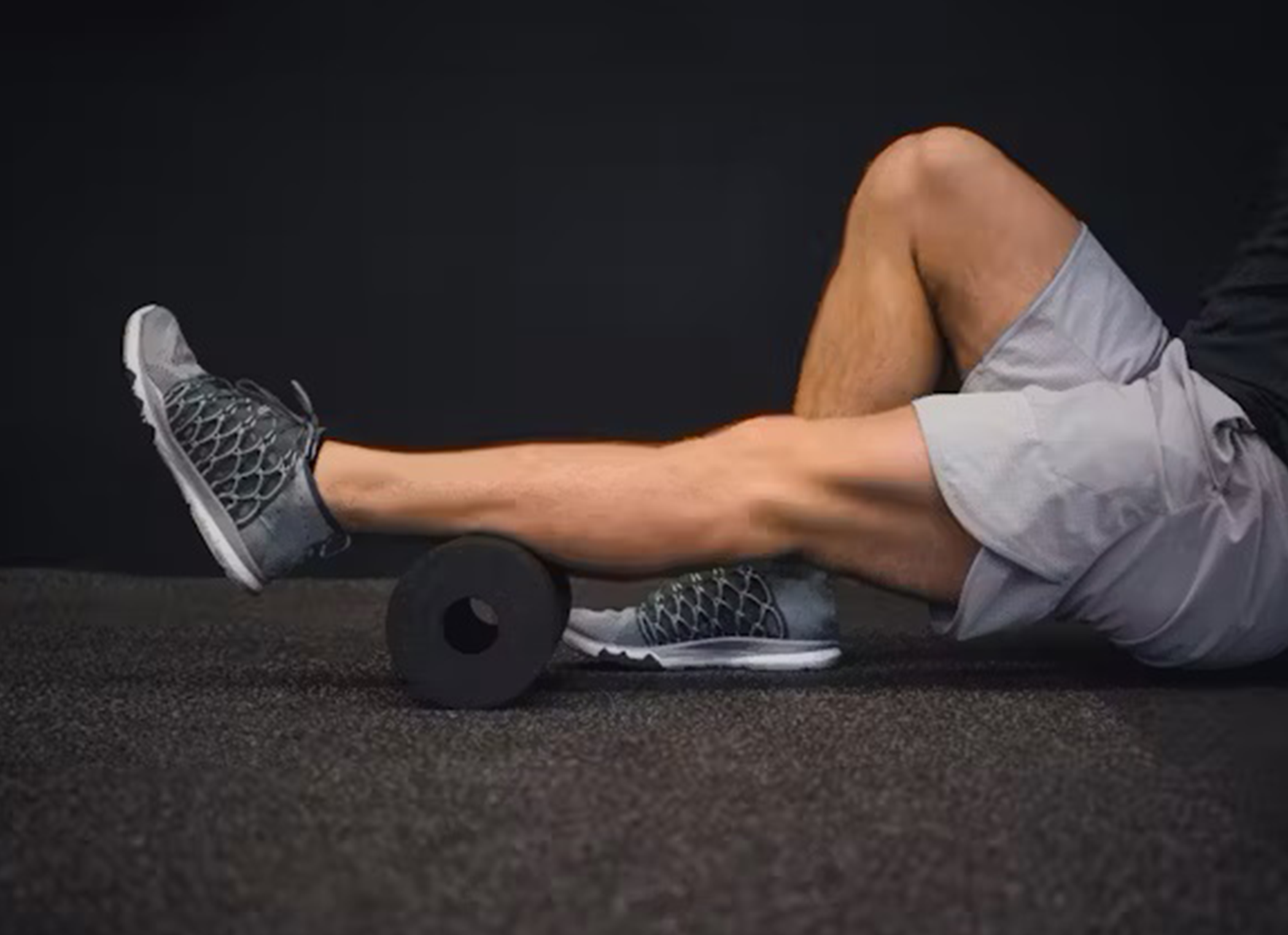 Man stretching sore leg muscles