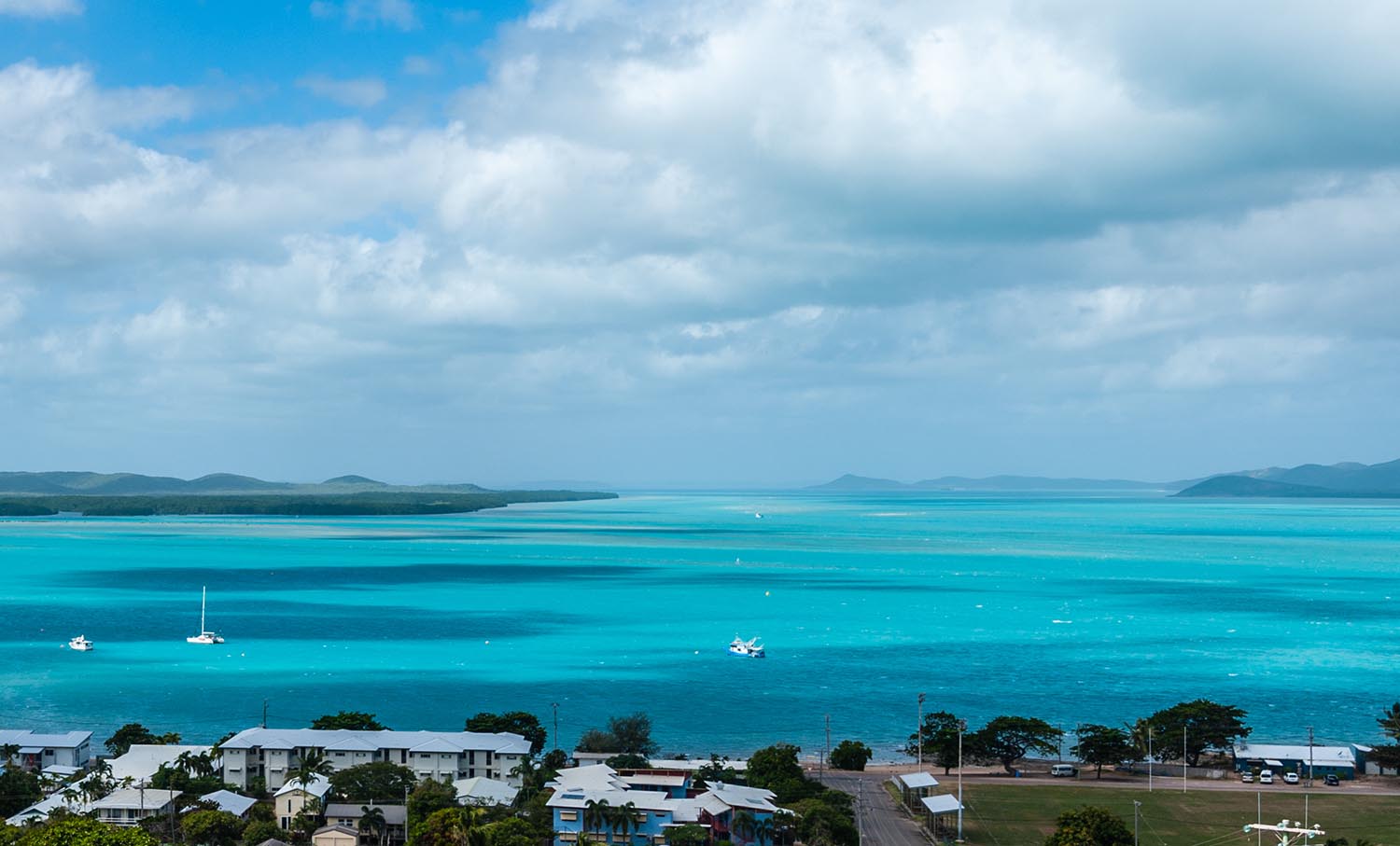 A view from high up of a bright, warm ocean and islands.