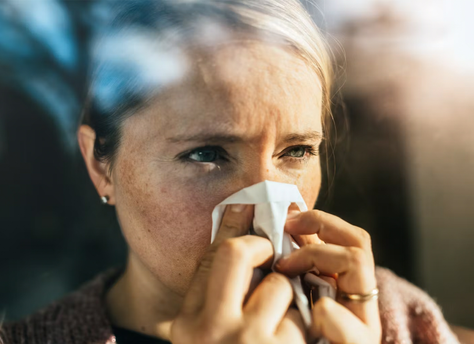 Woman blowing her nose