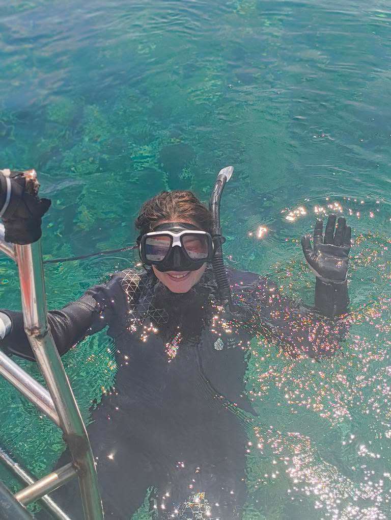 Talulah in the ocean holding mesh
