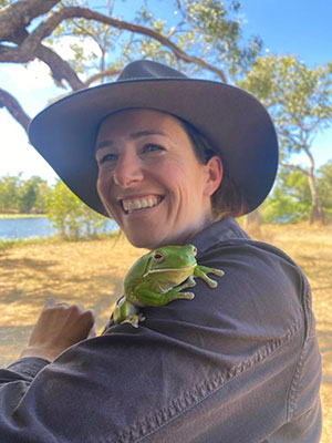 Gen with a white-lipped tree frog at AWC's Piccaninny Plains Sanctuary
