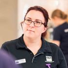 A female student in a QUT nurses uniform.
