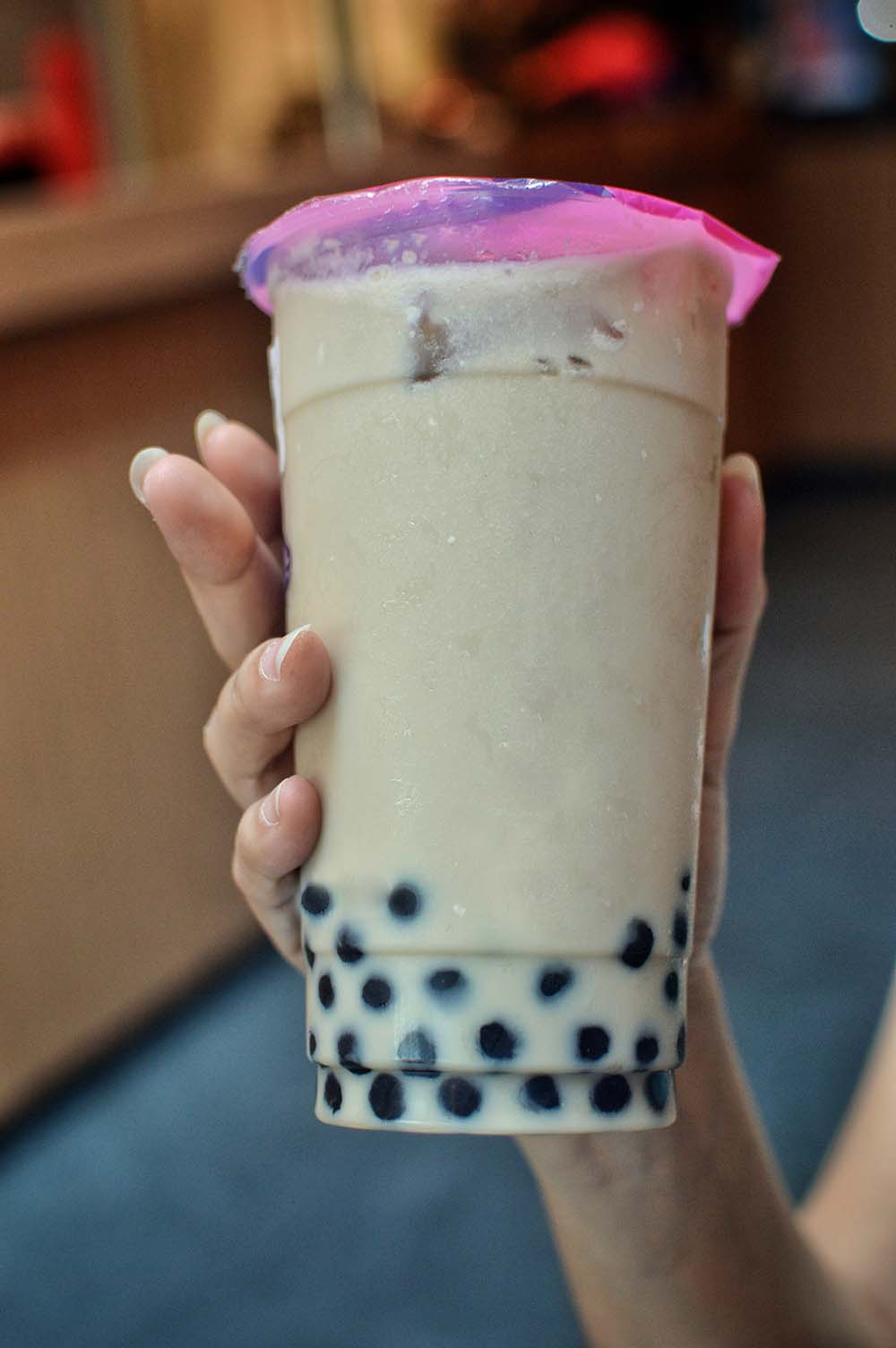 A hand holding a bubble tea.