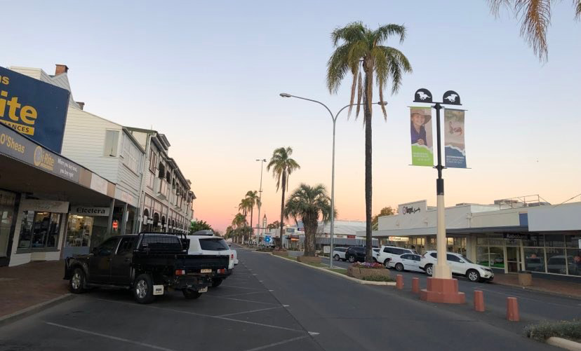 A rural main street at sunset.