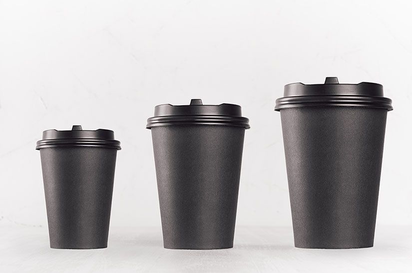 Three takeaway coffee cups in small, medium and large sizes