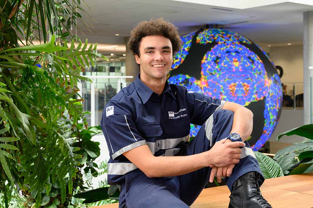 Rhys Daley, a proud Lama-Lama man wearing a paramedic uniform.