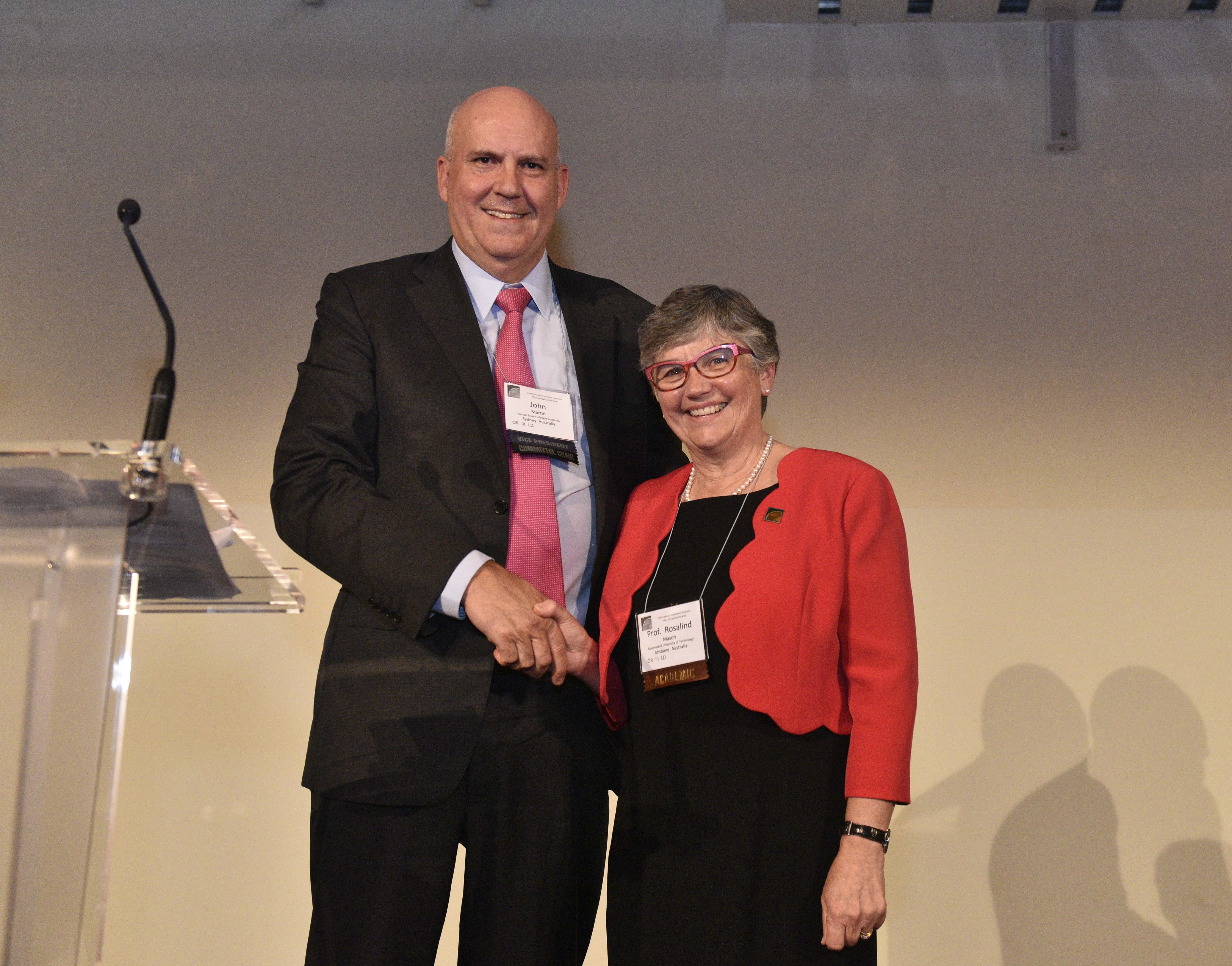John Martin, Partner, Norton Rose Fulbright and Vice-President of the International Insolvency Institute, presenting Professor Mason with the Founders Award at the III annual conference in Barcelona.